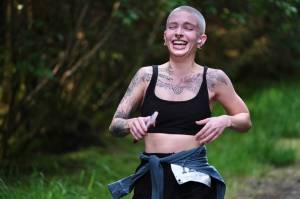 Grace Dumas approaches the finish of the East Glacier Trail Tangle on Tuesday. The 4.9-mile race follows part of Under Thunder Trail around East Glacier Trail and back. (Klas Stolpe / Juneau Empire)