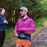 David Fure finishes the East Glacier Trail Tangle on Tuesday as race director Therese Pokorney records his time. The 4.9-mile race follows part of Under Thunder Trail around East Glacier Trail and back. (Klas Stolpe / Juneau Empire)