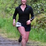 Grace Fluharty approaches the finish of the East Glacier Trail Tangle on Tuesday. The 4.9-mile race follows part of Under Thunder Trail around East Glacier Trail and back. (Klas Stolpe / Juneau Empire)