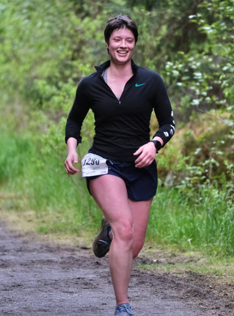 Grace Fluharty approaches the finish of the East Glacier Trail Tangle on Tuesday. The 4.9-mile race follows part of Under Thunder Trail around East Glacier Trail and back. (Klas Stolpe / Juneau Empire)