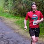 Quinn Tracy approaches the finish of the East Glacier Trail Tangle on Tuesday. The 4.9-mile race follows part of Under Thunder Trail around East Glacier Trail and back. (Klas Stolpe / Juneau Empire)