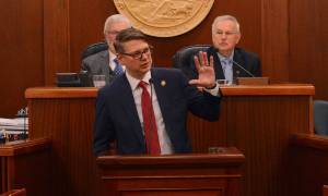 Rep. Nick Begich III, R-Alaska, speaks to the Alaska Legislature on Thursday, Feb. 20, 2025. At background are Senate President Gary Stevens, R-Kodiak (left) and Speaker of the House Bryce Edgmon, I-Dillingham (right). (James Brooks/Alaska Beacon)
