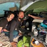 Douglas Ebey Worthington IV (left), Nathaniel Hensley-Williams (center) and Jason Williams discuss on Saturday, May 14, 2025, getting a notice Friday from police to vacate tent they share on Teal Street. They said they are unsure when they can and will move to next. (Mark Sabbatini / Juneau Empire)
