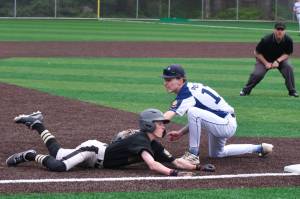 Juneaus Auke Bay Post 25 shortstop Kasen Ludeman attempts to tag Anchorages South Post 4 runner Mark Warren at third base during Alaska American Legion baseball action Saturday at Adair-Kennedy Memorial Park. (Klas Stolpe / Juneau Empire)