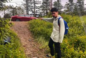 Chris Storey shows where he found an incapacitated man in an embankment along Glacier Highway in Lemon Creek during the early morning hours of Monday, June 16, 2025. (Mark Sabbatini / Juneau Empire)