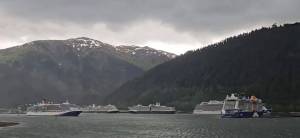 In this still image from a video provided to the Alaska Beacon, the cruise ship Celebrity Edge (at right) is seen drifting toward the Carnival Luminosa (at left). Three other cruise ships are seen moored to the Juneau docks. (Video screenshot)