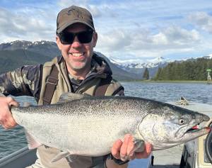 The author with a king salmon caught on a fly rod. (Photo courtesy of Jeff Lund)