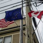 The U.S., Alaska state flag, and Canada flag wave in the wind in Skagway on Monday, June 16, 2025. (Jasz Garrett / Juneau Empire)