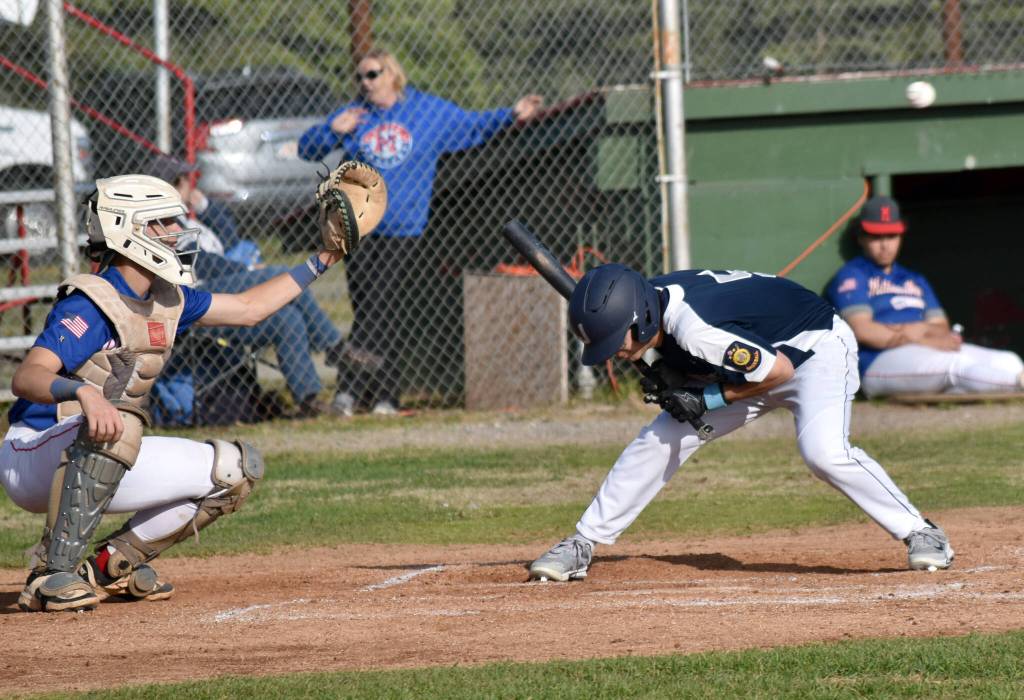 Jacob Katasse of Auke Bay Post 25 ducks under a pitch in front of catcher Conner Mitchuson of Madisonville (Kentucky) Post 6 on Friday, June 20, 2025, in the Lance Coz Wood Bat Tournament at Coral Seymour Memorial Park in Kenai, Alaska. (Photo by Jeff Helminiak/Peninsula Clarion)