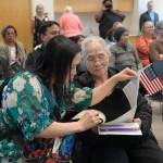Lynn Le translates paperwork for her mother on Tuesday, June 24, 2025. (Jasz Garrett / Juneau Empire)