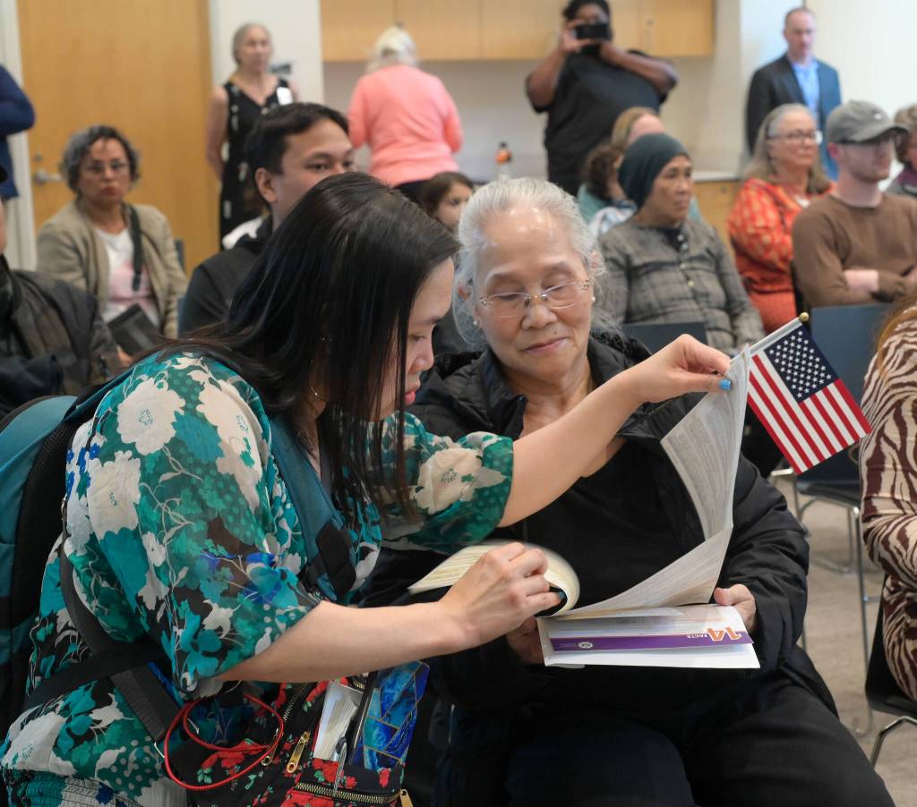 Lynn Le translates paperwork for her mother on Tuesday, June 24, 2025. (Jasz Garrett / Juneau Empire)