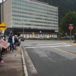 Demonstrators listen to speaker Heidi Drygas, executive director of Alaska State Employees Association on Friday, June 27, 2025. (Natalie Buttner / Juneau Empire)