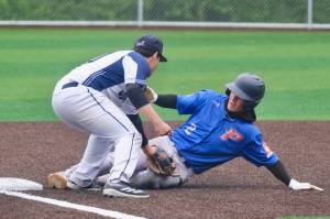Juneaus Auke Bay Post 25 third baseman Madden Mendoza tags out Palmer Post 15 base runner Reed Craner (2) during Juneaus 7-6 win over Palmer in American Legion Baseball action Sunday at Adair Kennedy Memorial Park. (Klas Stolpe / Juneau Empire)