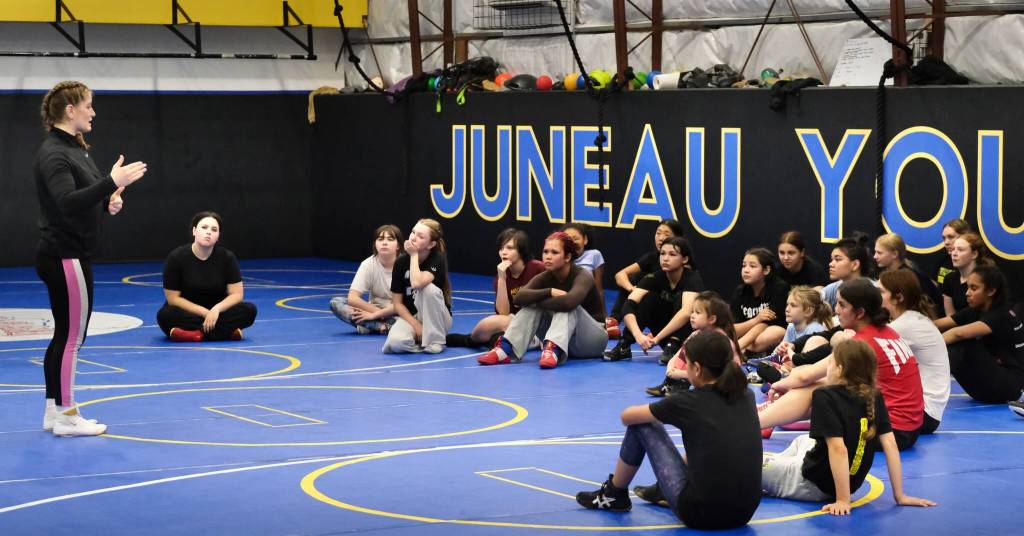 2024 Olympic wrestling gold medalist Amit Elor, 21, talks to camp wrestlers during the Juneau Girls Wrestling Clinic on Tuesday at the Juneau Wrestling Center. (Klas Stolpe / Juneau Empire)