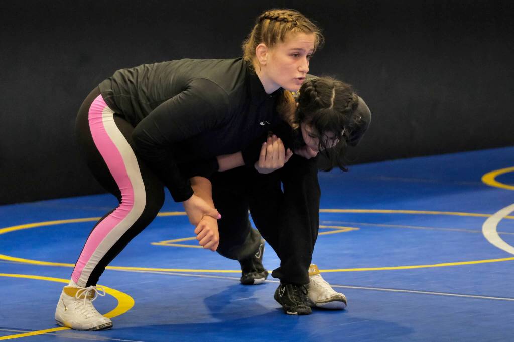 2024 Olympic wrestling gold medalist Amit Elor, 21, center, demonstrates a counter move on JDHS sophomore Toriana Johnson, 15, during the Juneau Girls Wrestling Clinic on Tuesday at the Juneau Wrestling Center. (Klas Stolpe / Juneau Empire)