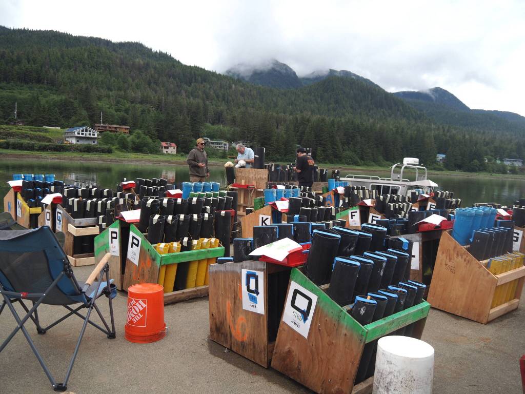 Volunteers work on the barge deck where fireworks are being staged on Thursday<ins>, July 3, 2025</ins>. (Natalie Buttner / Juneau Empire)