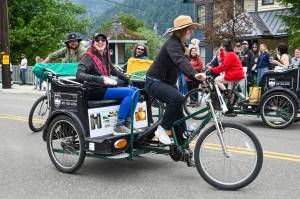 Shannon Crossley, who helped build the Treadwell disc golf course, wears the Douglas grand marshals sash as she rides in the parade on Friday, July 4, 2025. (Jasz Garrett / Juneau Empire)