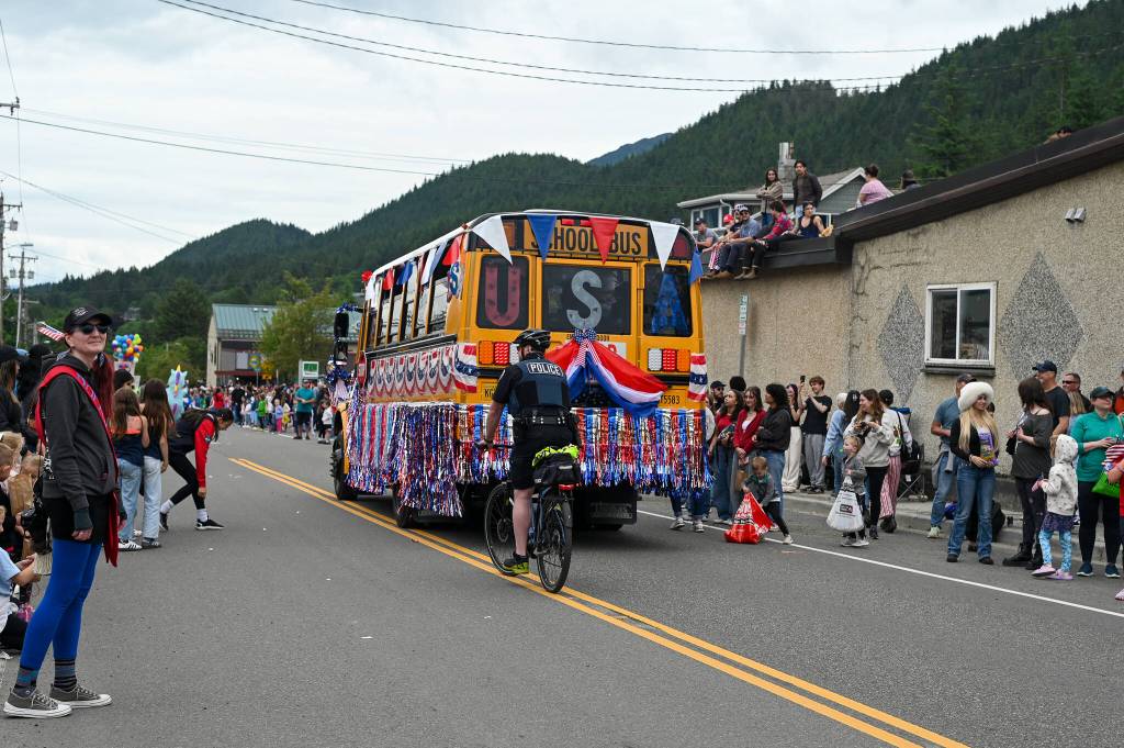 Shannon Crossley (left) watches the Douglas parade on Friday, July 4, 2025. (Jasz Garrett / Juneau Empire)