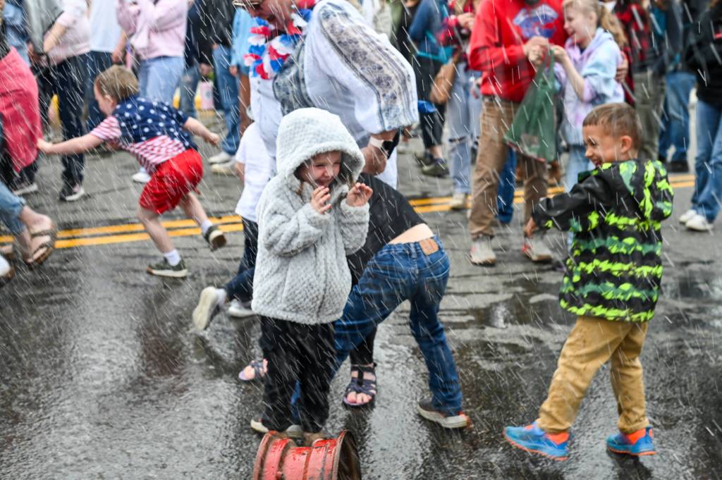 Children are sprayed by Capital City Fire/Rescue firemens hoses on Friday, July 4, 2025. (Jasz Garrett / Juneau Empire)