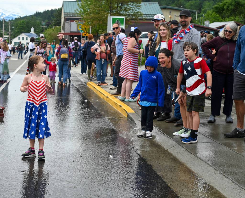 Madeline Blasco, 5, enjoys playing in the water after the annual Olde Time Firemens Hose Race on Friday, July 4, 2025. (Jasz Garrett / Juneau Empire)
