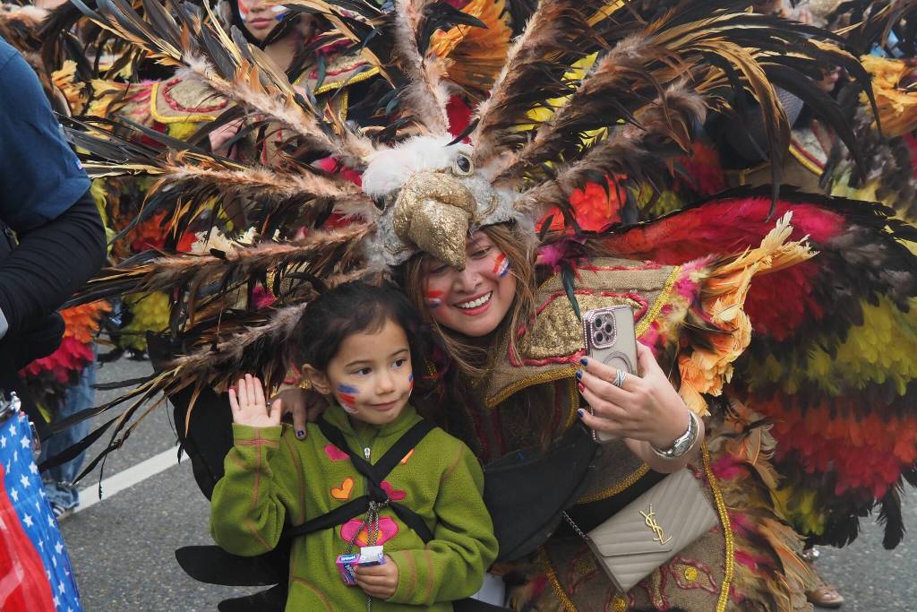 Members of Juneau Ati-Atihan pause to take a photo during the 2025 downtown Juneau Fourth of July parade. (Natalie Buttner / Juneau Empire)