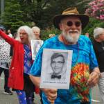 John Lancaster holds up his high school portrait as part of the Juneau-Douglas High School: Yadaa.at Kalé Class of 1970, which is celebrating its 55-year reunion on Friday, July 4, 2025. (Natalie Buttner / Juneau Empire)