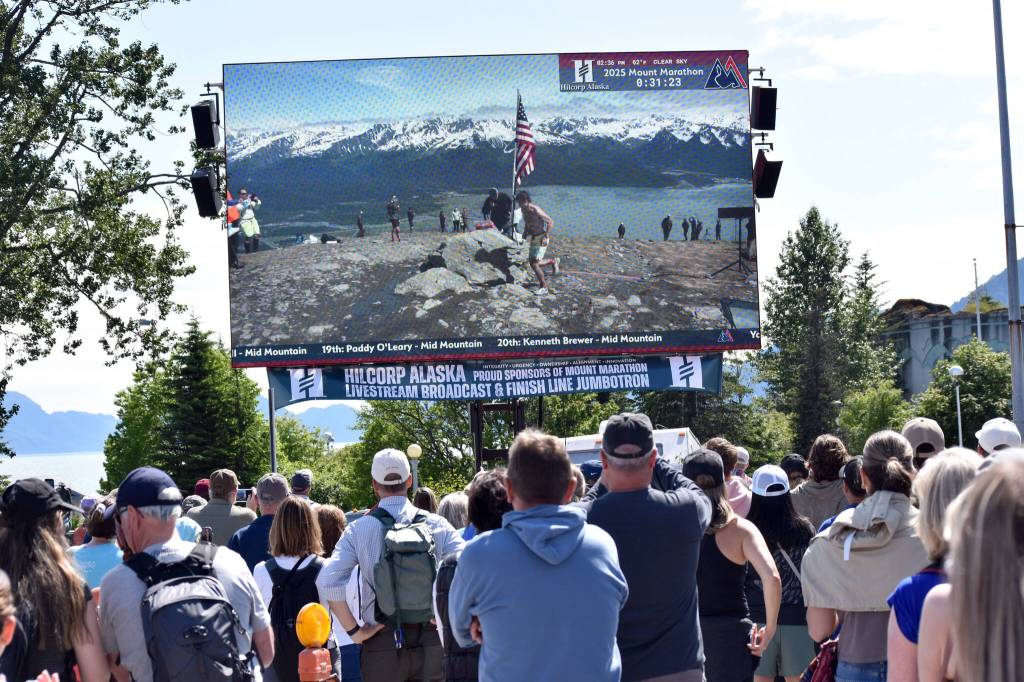 Spectators watch as David Norris, 34, of Steamboat Springs, Colorado, round race point at the Mount Marathon Race on July 4, 2025, in Seward, Alaska. (Photo by Jeff Helminiak/Peninsula Clarion)