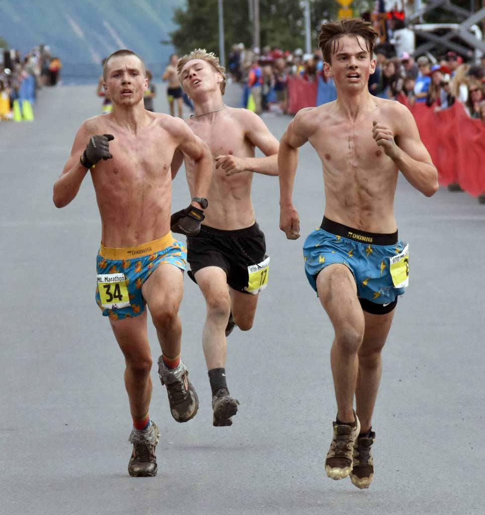 Anchorages Ole Reese, 15; Sewards Ridge Conant, 16; and Eagle Rivers Cohen Galloway, 17, race to the line in the junior boys race at the Mount Marathon Race on July 4, 2025, in Seward, Alaska. (Photo by Jeff Helminiak/Peninsula Clarion)