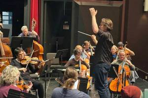 Brad Hogarth, one of four finalists to be the new music director of the Juneau Symphony, guides the ensemble through a rehearsal at Juneau-Douglas High School: Yadaa.at Kalé. (Mark Sabbatini / Juneau Empire file photo)