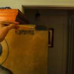 Tatiana McWethy points to the unrestored corner of the icon of St. Nicholas. (Photo by Charles Whittlesey)