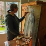 Tatiana McWethy demonstrates her restoration technique on the icon of St. Nicholas (Photo by Charles Whittlesey)