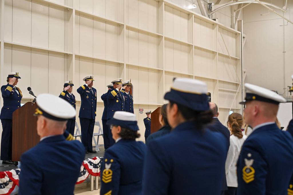 Members of the U.S. Coast Guard salute during the opening of the transfer of command ceremony on Friday, July 11, 2025. (Jasz Garrett / Juneau Empire)