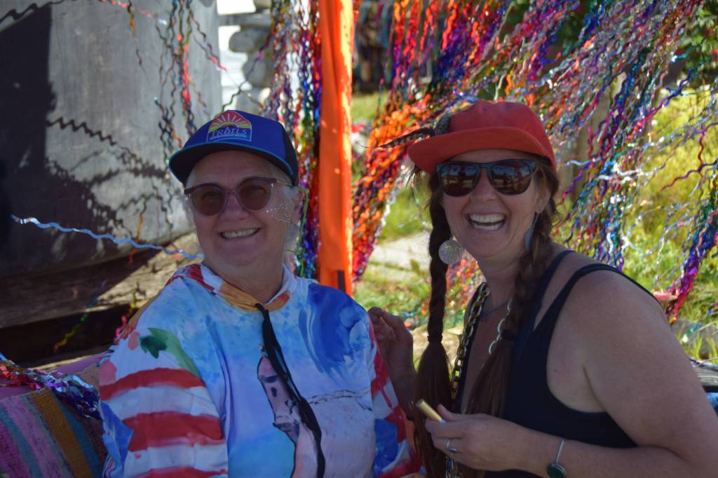 Attendees smile for a photo in between being bedazzled on Friday, Aug. 2, during the 2025 Salmonfest at Kenai Peninsula Fairgrounds. (Chloe Pleznac/Homer News)