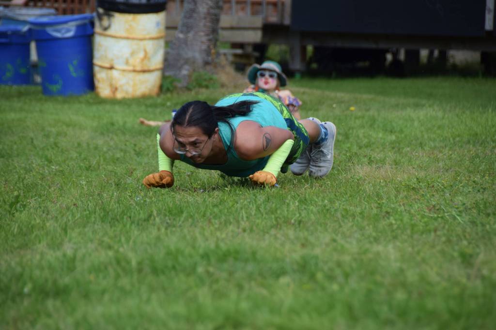 Fairbankss Trevor Edwards demonstrates a knuckle seal hop while a curious clown looks on during Salmonfest 2025 on Friday, Aug. 2, at the Kenai Peninsula Fairgrounds in Ninilchik. (Chloe Pleznac/Homer News)