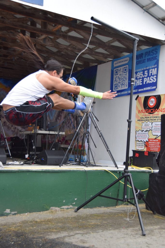 Trevor Edwards performs the 2-foot high kick during a Native Youth Olympics demonstration at the Inlet Stage on Saturday, Aug. 2, 2025, at the Kenai Peninsula Fairgrounds in Ninilchik, Alaska. (Delcenia Cosman/Homer News)