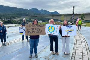Protesters hold signs at the No War Criminals protest at The Whale in Bill Overstreet Park in Juneau, Alaska, on Friday, Aug. 15, 2025. (Photo provided by Juneau For Democracy)