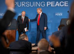 Russian President Vladimir Putin and President Donald Trump begin to leave the stage after making statements following their meeting in Anchorage, Alaska, Aug. 15, 2025. (Doug Mills/The New York Times)