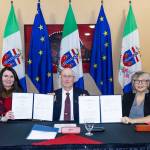 Jeanie McLean, James Cockrell and Tracy-Anne McPhee signed a memorandum of understanding on behalf of Yukon and Alaska on Aug. 12, 2025, to share information on gender-based violence in the North. (Yukon government/Yukon.ca)