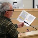 David Haeg reads from an annotated copy of a grand jurists handbook during a town hall on the Alaska grand jury process in the Betty J. Glick Assembly Chambers in Soldotna, Alaska, on Monday, Aug. 18, 2025. (Jake Dye/Peninsula Clarion)