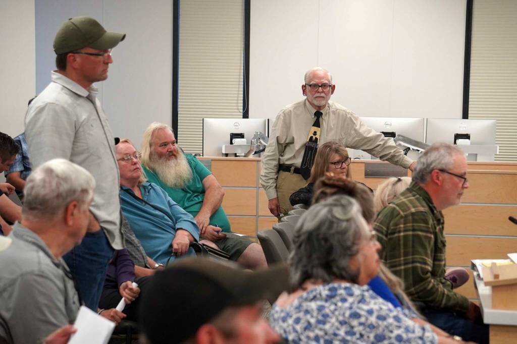 Former Alaska House Rep. Ben Carpenter and Ray Southwell rise in support of speaker David Haeg during a town hall on the Alaska grand jury process in the Betty J. Glick Assembly Chambers in Soldotna, Alaska, on Monday, Aug. 18, 2025. (Jake Dye/Peninsula Clarion)