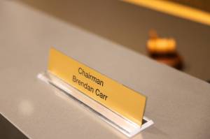 The nameplate of Brendan Carr, chairman of the Federal Communications Commission, at a hearing in Washington on Feb. 27, 2025. While Jimmy Kimmel Live! returned to ABC on Sept. 23, Carr has promised to continue his campaign against what he sees as liberal bias in broadcasts. (Tierney L. Cross/The New York Times)