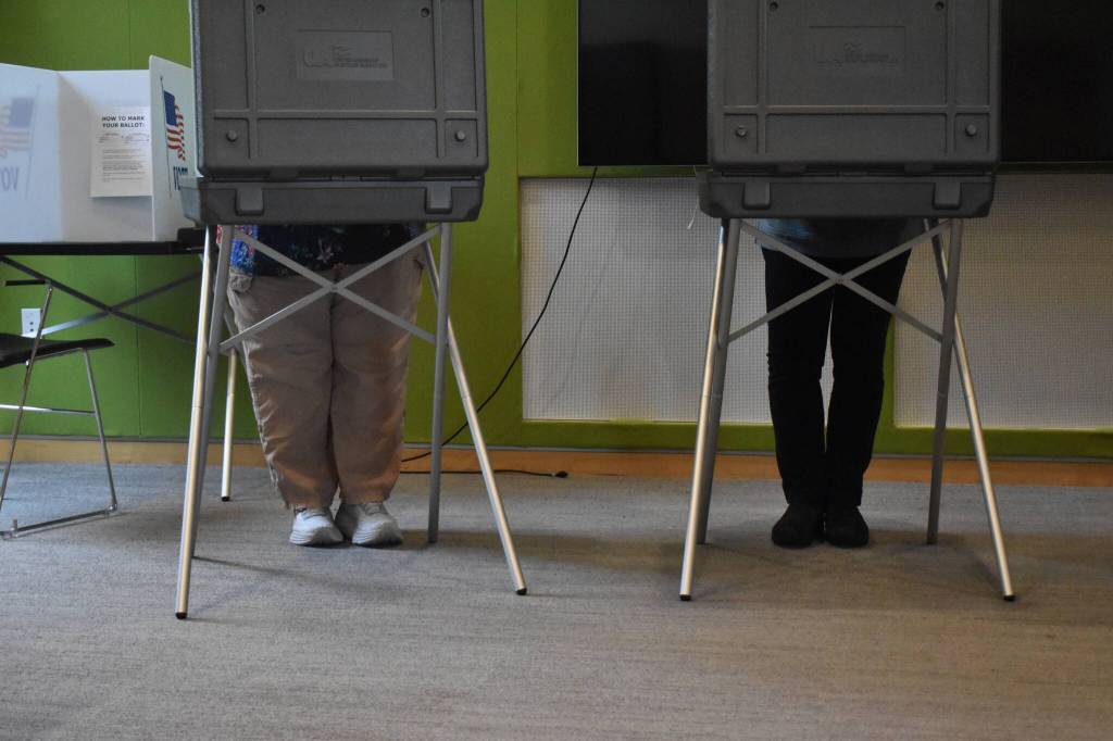 Poll workers at the Mendenhall Valley Public Library pose for a photo. (Mari Kanagy / Juneau Empire)