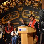Mari Kanagy / Juneau Empire 
Sukteeneidí Spokesperson Ed Thomas speaks to a full audience at the at the Shuká Hít (clan house) in the Walter Soboleff Building, standing before Sukteeneidí Clan elders.