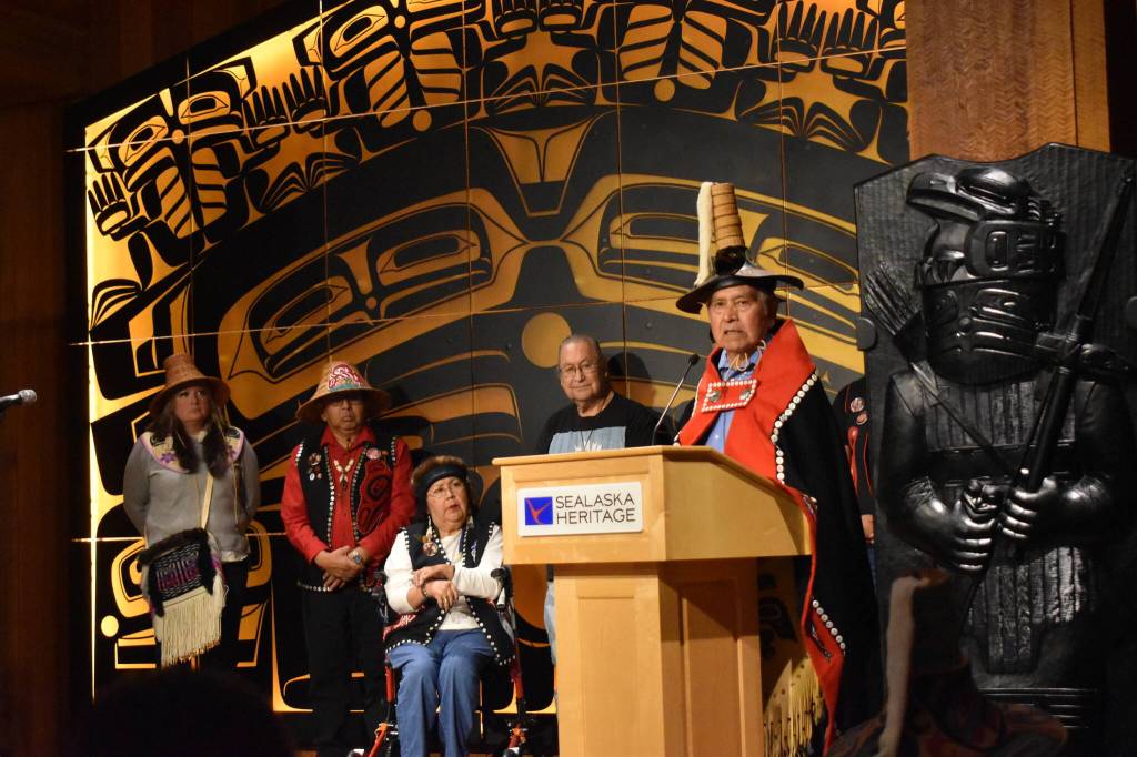 Mari Kanagy / Juneau Empire 
Sukteeneidí Spokesperson Ed Thomas speaks to a full audience at the at the Shuká Hít (clan house) in the Walter Soboleff Building, standing before Sukteeneidí Clan elders.