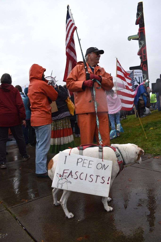 One dog at the No Tsars, No Kings wears a sign that says, I Pee on Fascists! (Mari Kanagy/Juneau Empire)