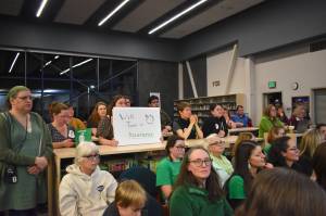 Members of Juneau Education Association and supporters of the union dress in green at the Board of Education Meeting on Oct. 28, 2025. (Mari Kanagy/Juneau Empire)