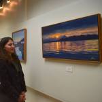 Mari Kanagy/Juneau Empire
Local artist Johanna Griggs looks at The Ocean Mirror, her favorite piece from her exhibit Landscapes of Southeast Alaska, on display at the Juneau Arts and Culture Center.