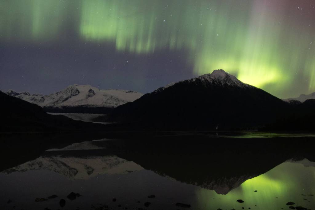 The aurora borealis dances over the Mendenhall Glacier in Juneau on Nov. 12, 2025. Hundreds of Juneauites flocked to dark areas of town to catch particularly strong performances from the northern lights due to a series of solar flares Tuesday and Wednesday nights. (Chloe Anderson/Peninsula Clarion)