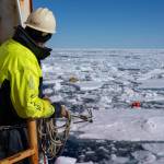 Eric Boget, a research engineer aboard the U.S. Coast Guard Cutter Healy (WAGB 20), prepares to throw a grappling hook to recover an Arctic Mobile Observing System (AMOS) mooring while Healy operating in the Arctic Ocean, July 21, 2025. (U.S. Coast Guard Photo by Petty Officer 3rd Class Chris Sappey)