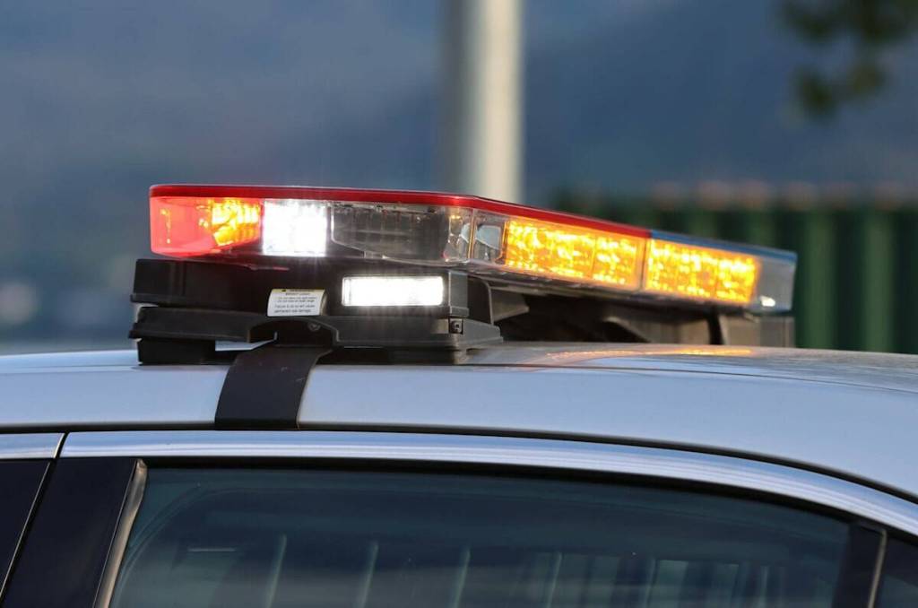 Emergency lights flash on top of a police car. (Ben Hohenstatt / Juneau Empire file photo)